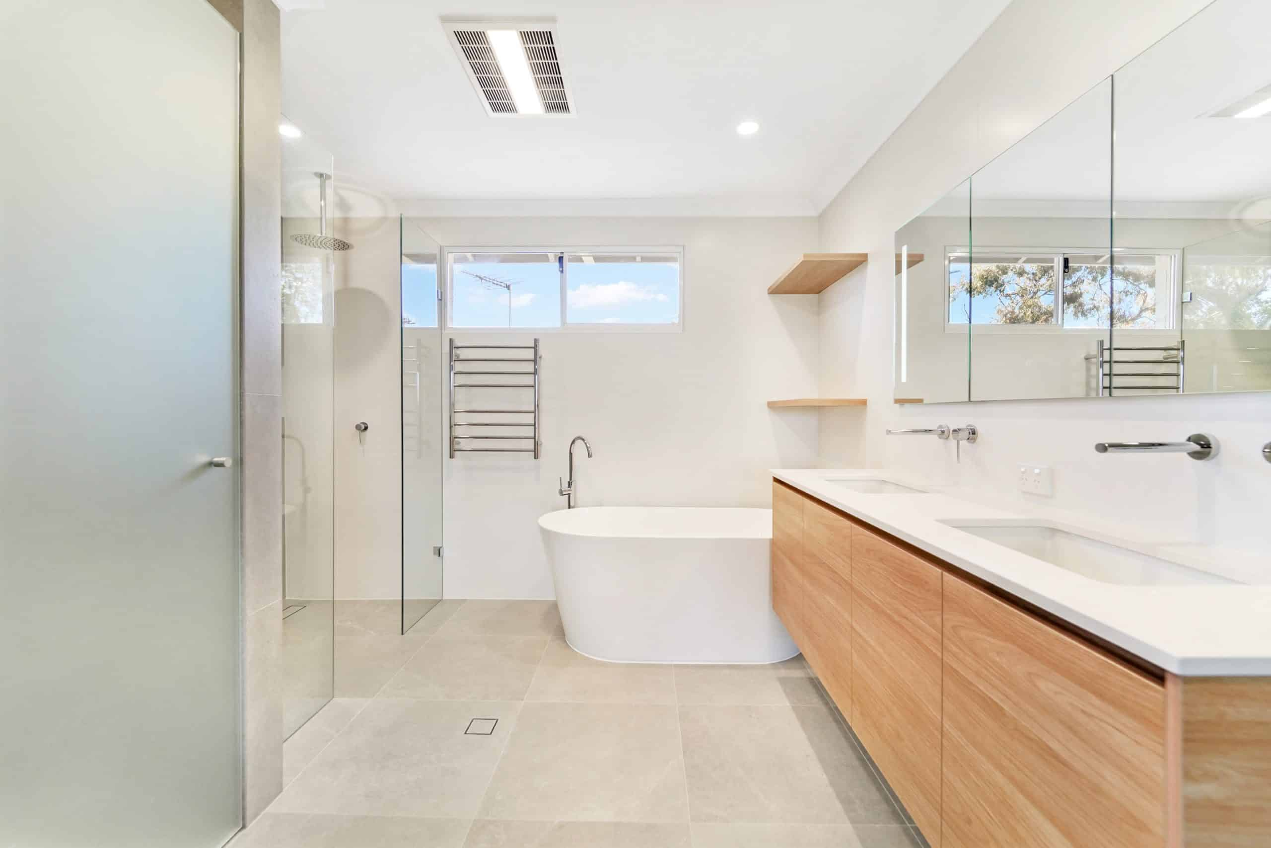 Modern bathroom with wood vanity and freestanding tub